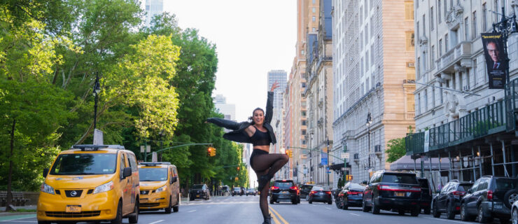 Dancer Maci Arms holding a dance pose in the middle of an NYC street.