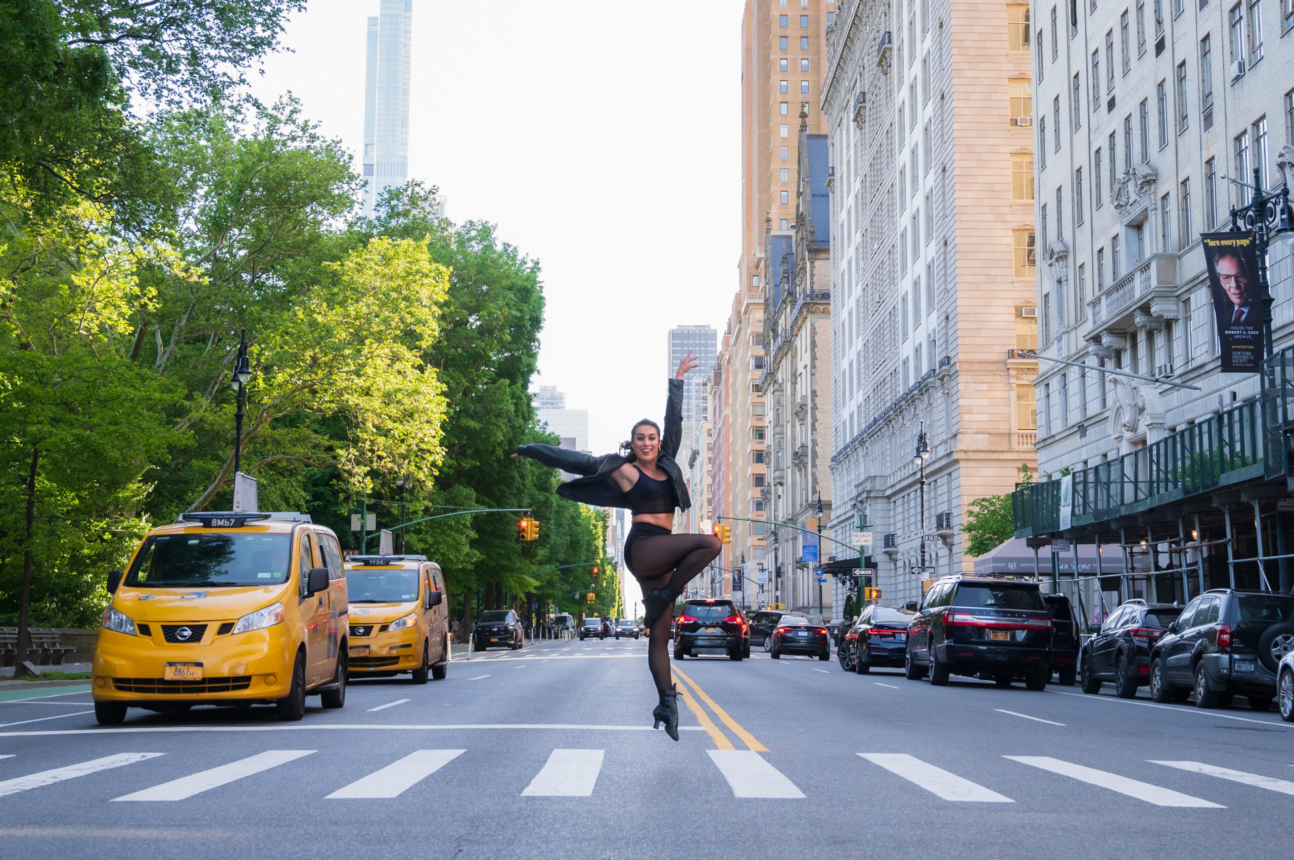 Dancer Maci Arms holding a dance pose in the middle of an NYC street.