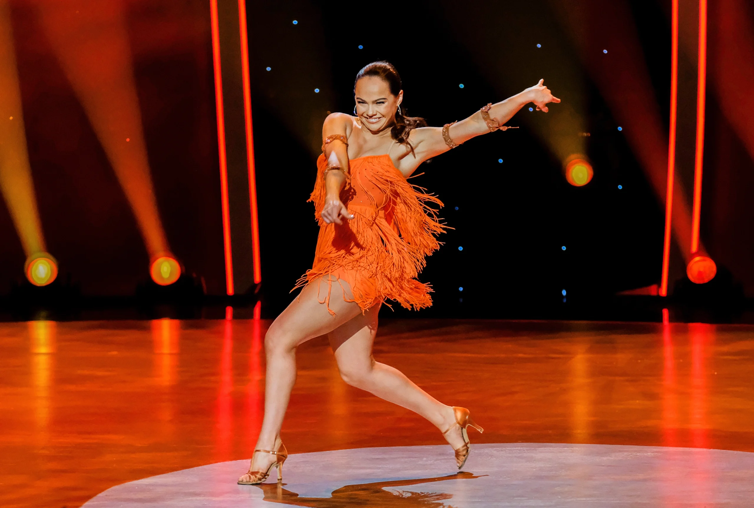 “So You Think You Can Dance” Season 17 champion Alexis Warr performing in an orange dress.