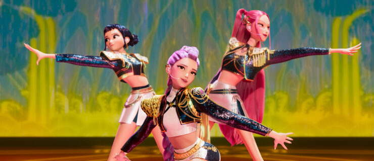 A still from "KPop Demon Hunters" showing three female K-Pop stars performing onstage.