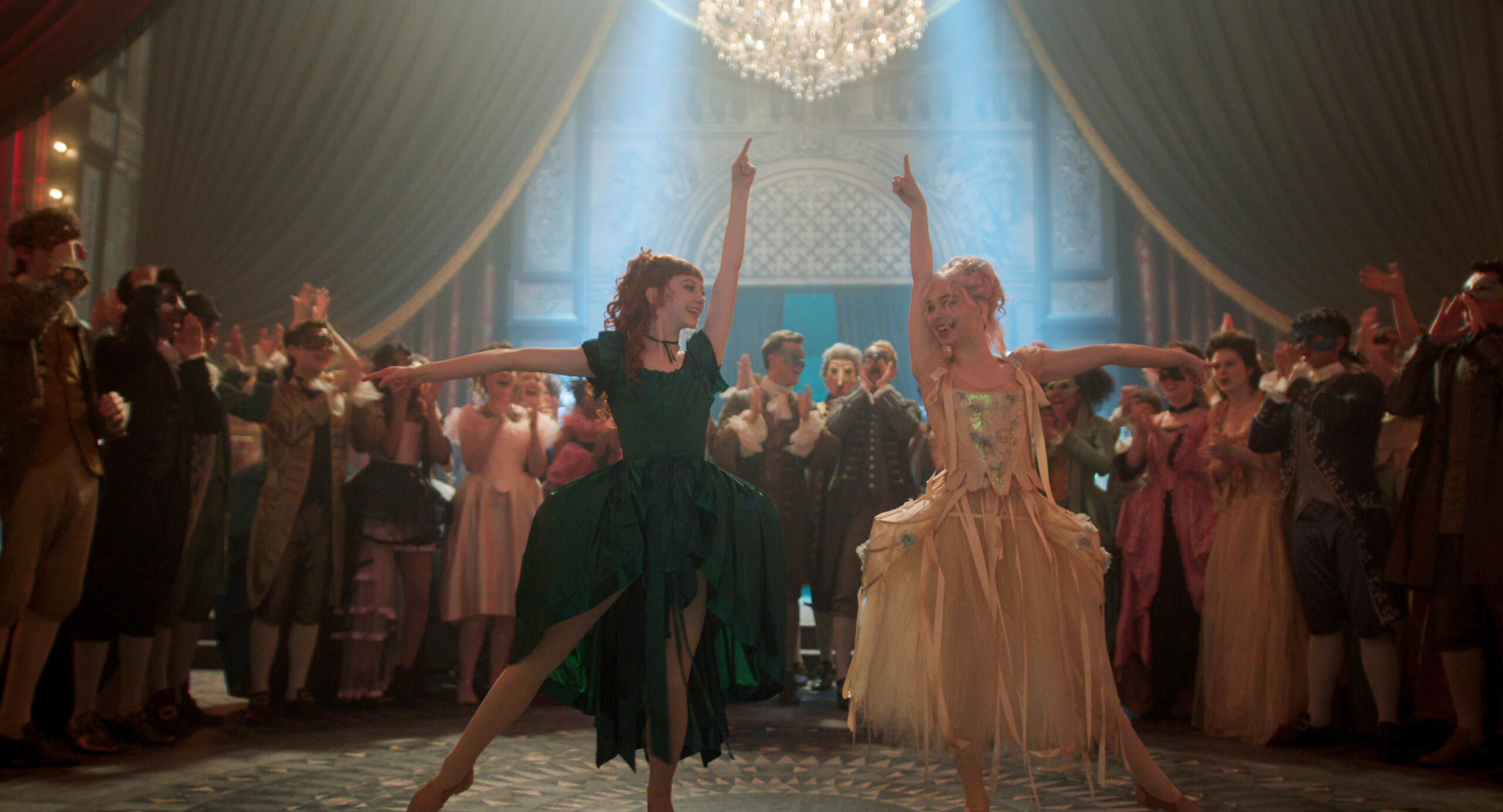 On the set of "Wednesday," two dancers in Venetian dress point up and to the side, hips bumping in toward another in tendu a la seconde, as they perform for a crowd in an ornate ballroom.