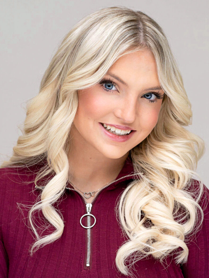 Jocelyn Mastro's headshot. She has blonde hair and wears a red zip-up.