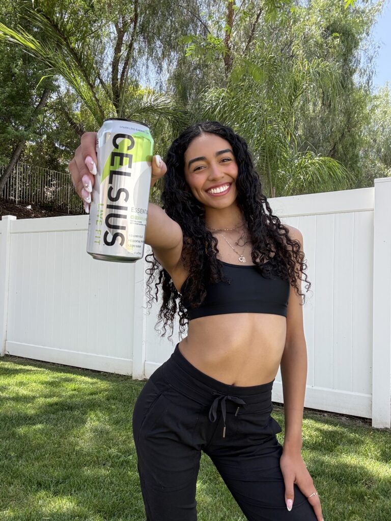 Briana Baldovinos poses outdoors with a can of Celsius.
