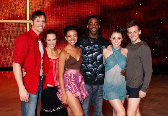 A group of dancers huddle for a group photo on set at "So You Think You Can Dance."