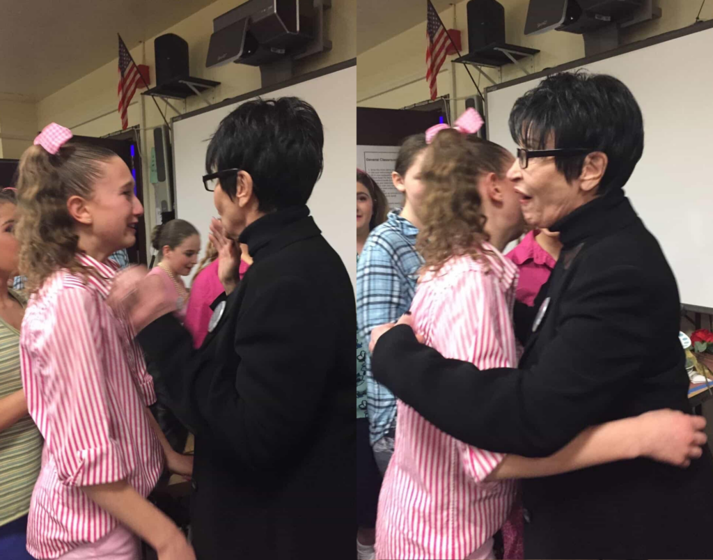 Two photos, side-by-side, show Helena Padial and Chita Rivera first speaking, then hugging. Padial cries and wears a white and pink striped dress with a bow in her hair, and Rivera wears all black.